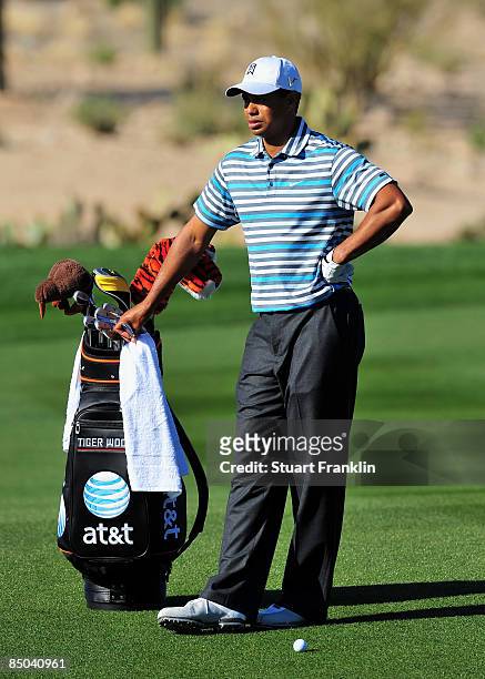 Tiger Woods of the USA rests on his golf bag during practice prior to the start of the Accenture Match Play Championships at Ritz - Carlton Golf Club...
