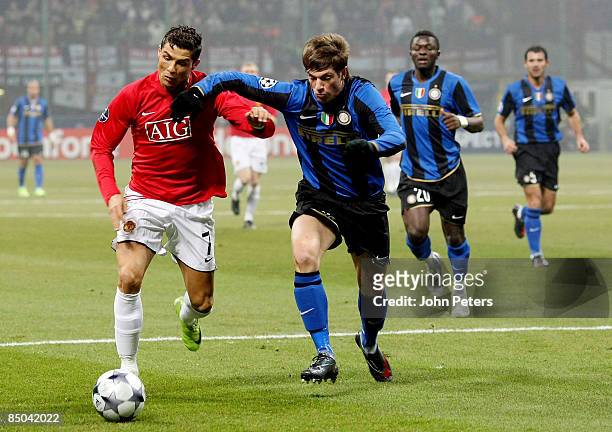 Cristiano Ronaldo of Manchester United clashes with Davide Santon of Inter Milan during the UEFA Champions League First Knockout Round First Leg...