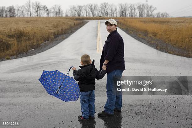 Former soldier Pvt. Lynndie Rana England and her son Carter Allan England pose for a photograph at the industrial park on March 7, 2008 in Fort...