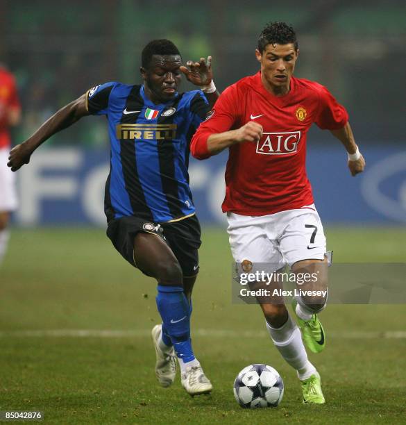 Sulley Muntari of Inter Milan attempts the tackle on Cristiano Ronaldo of Manchester United during the UEFA Champions League, Round of Last 16, First...