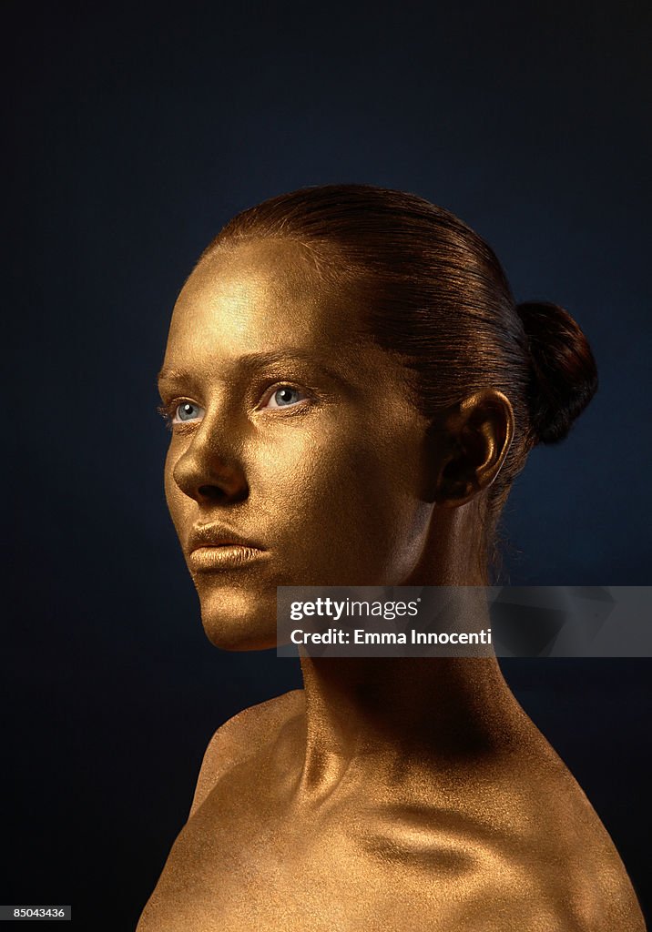 Portrait of young woman in Gold