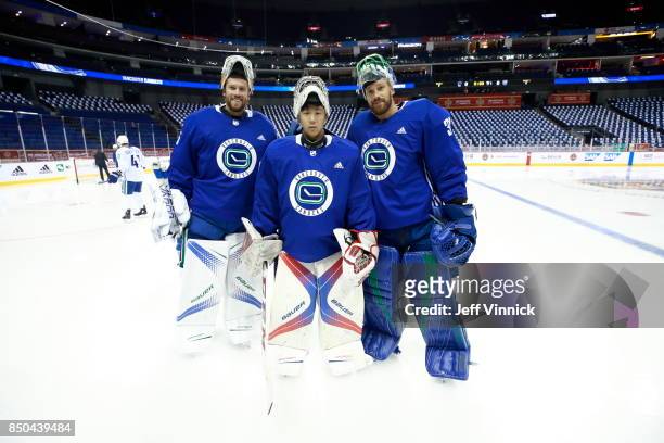 Vancouver Canucks backup goaltender Zehao Sun poses for a photo with Jacob Markstrom and Anders Nilsson during their game-day skate at Mercedes-Benz...