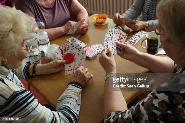 Elderly women play a cards game of rummy at the Mireille Mathieu senior citizens' center on September 20, 2017 in Berlin, Germany. According to...