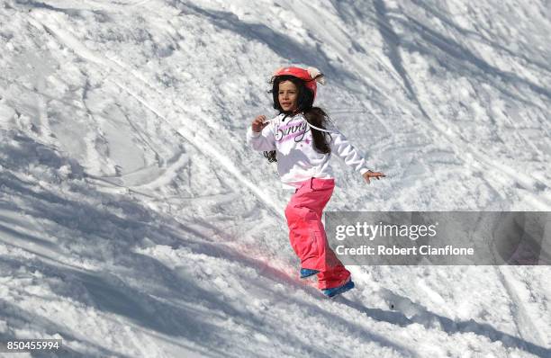 Young girl plays in the snow on September 21, 2017 in Mount Buller, Australia. Australians are enjoying one of the best ski seasons after the best...