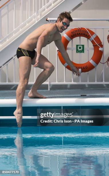 Chris Cook, former Olympic swimmer and Just a Drop School Ambassador dips a toe in one of the pools on board Norwegian Cruise Line's new ship, the...