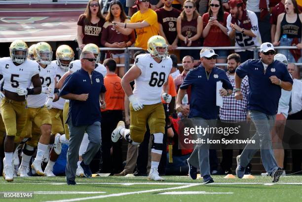 Notre Dame head coach Brian Kelly leads his team onto the field before a game between the Boston College Eagles and the Notre Dame Fighting Irish on...