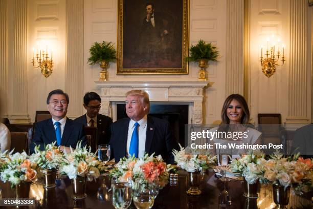 President Donald Trump, First Lady Melania Trump, South Korean President Moon Jae-in, left, and his wife Kim Jeong-suk, talk during a dinner in the...