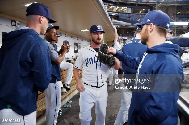 Travis Wood of the San Diego Padres is greeted by teammates prior to the start of the game against the St Louis Cardinals at Petco Park on September...