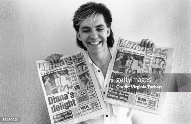 Photo of Nick RHODES and DURAN DURAN, Nick Rhodes, posed, holding copies of the Daily Mirror featuring story about band meeting Pricess Diana