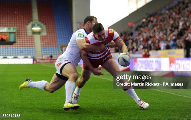 Wigan Warriors Anthony Gelling goes over for a try past Salford City Reds' Danny Williams during the Super League match at the DW Stadium, Wigan.