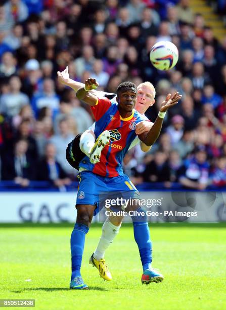 Crystal Palace's Wilfried Zaha and Peterborough United's Craig Alcock battle for the ball during the npower Football League Championship match at...