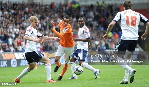 Blackpool's Tom Ince battles for the ball with Bolton Wanderers Tim Ream Medo Kamara and Sam Ricketts during the npower Football League Championship...