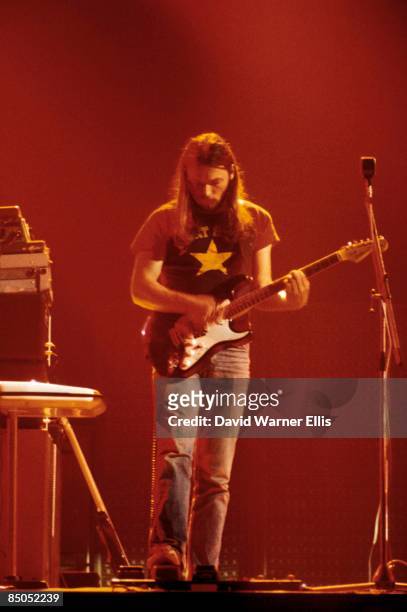 David Gilmour playing Fender Stratocaster guitar, using wah wah pedal performing live onstage at Shelter benefit concert on 'Dark Side Of The Moon'...