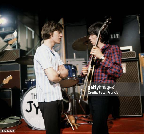 Photo of Keith RICHARDS and Mick JAGGER and ROLLING STONES, Mick Jagger and Keith Richards talking on the set of Ready Steady Go! TV Show at...
