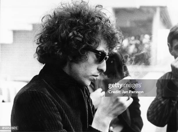 Photo of Bob DYLAN; posed, wearing sunglasses, holding cigarette