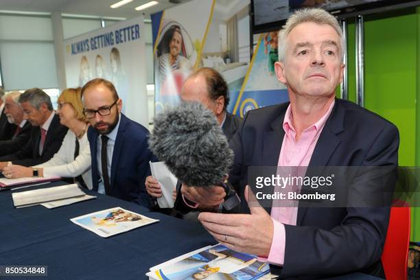 Michael O'Leary, chief executive officer of Ryanair Holdings Plc, handles a microphone ahead of the company's annual general meeting in Dublin,...