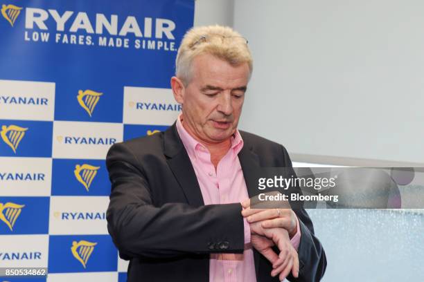 Michael O'Leary, chief executive officer of Ryanair Holdings Plc, looks at his watch ahead of the company's annual general meeting in Dublin,...