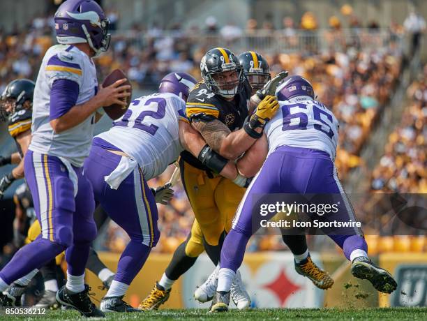 Defensive end Tyson Alualu of the Pittsburgh Steelers battle with offensive guard Nick Easton of the Minnesota Vikings and center Pat Elflein of the...