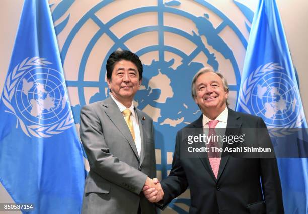 Japanese Prime Minister Shinzo Abe and United Nations Secretary-General Antonio Guterres shake hands prior to their meeting at the U.N. Headquarters...