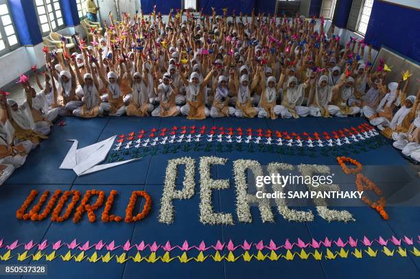 Indian schoolchildren take part in an event to mark the United Nation's International Day of Peace at Anjuman-E-Islam School in Ahmedabad on...