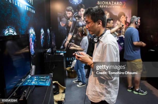 Visitors play the Biohazard revelations 2 video game on Nintendo Co.'s Switch game consoles in the Capcom Co. Booth during the Tokyo Game Show 2017...