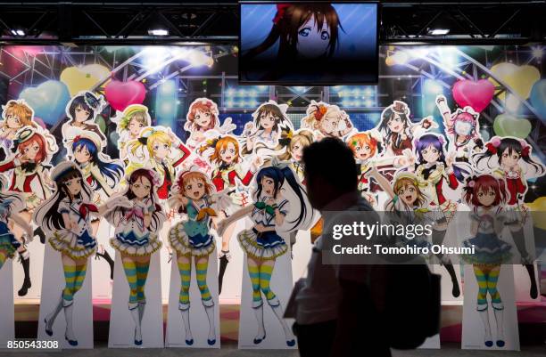 Man walks past a display of the School Idol Festival video game during the Tokyo Game Show 2017 at Makuhari Messe on September 21, 2017 in Chiba,...