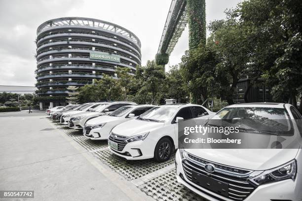 Co. Vehicles stand in front of a charging parking lot tower at the company's headquarters in Shenzhen, China, on Thursday, Sept. 21, 2017. China will...