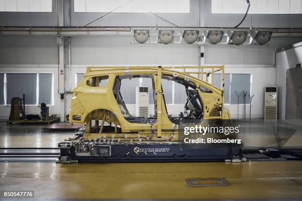 Vehicle frame sits on a Seattle Safety LLC testing sled in a lab at the BYD Co. Headquarters in Shenzhen, China, on Thursday, Sept. 21, 2017. China...