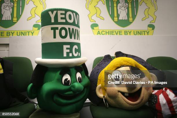 The heads of the two club mascot outfits lay on a row of chairs at Huish Park, before the match