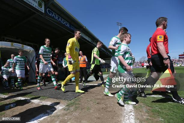 Players from both sides take to the field of play for the start of the game