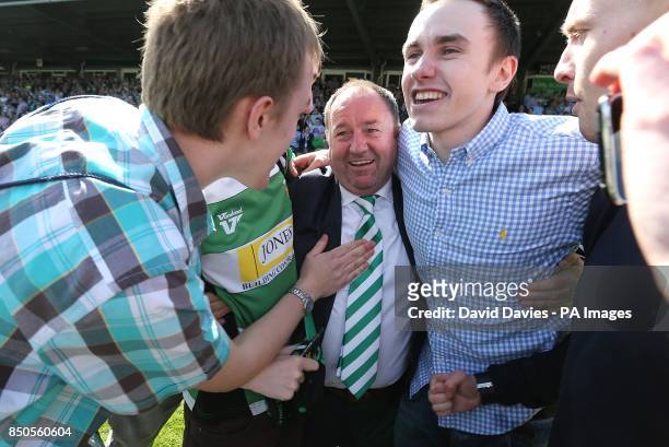 Yeovil Town manager Gary Johnson is mobbed by fans as they celebrate on the pitch after the final whistle