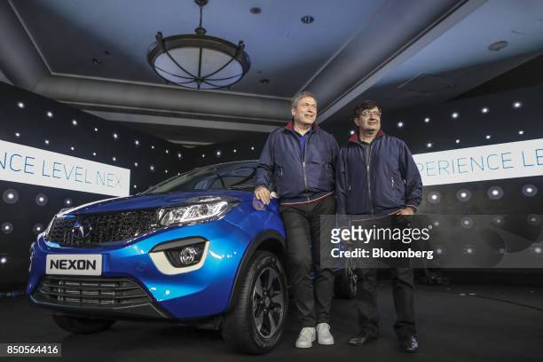 Guenter Butschek, chief executive officer of Tata Motors Ltd., left, and Mayank Pareek, president of passenger vehicles at Tata Motors Ltd., pose for...