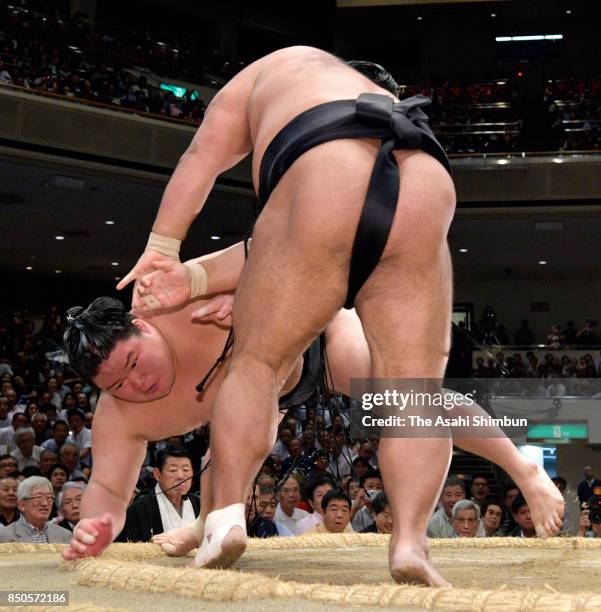 Shohozan throws ozeki Goeido to win during day twelve of the Grand Sumo Autumn Tournament at Ryogoku Kokugikan on September 21, 2017 in Tokyo, Japan.