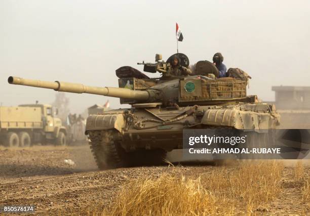 An Iraqi forces' Russian-made T-72 tank advances towards the city of al-Sharqat on September 21 where Iraqi forces backed by Hashed al-Shaabi...