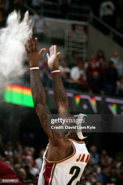 LeBron James of the Cleveland Cavaliers tosses talc powder into the air as part of his warm-up prior to the game against the Memphis Grizzlies at the...