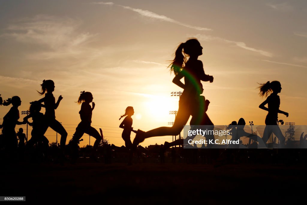 Runners compete in a 5k at sunset in Corona, California.