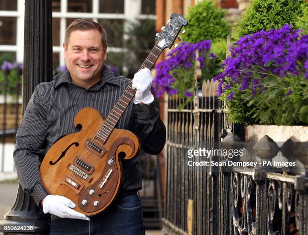 Darren Julien President and CEO of Julien's Auctions with a rare VOX guitar played by George Harrison and John Lennon during The Beatles 1967 Magical...