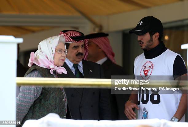 The Queen talks to the King of Bahrain Hamad bin Isa bin Salman Al Khalifa and his son Shiekh Khalid bin Hamad Al Khalifa at the finish line for the...