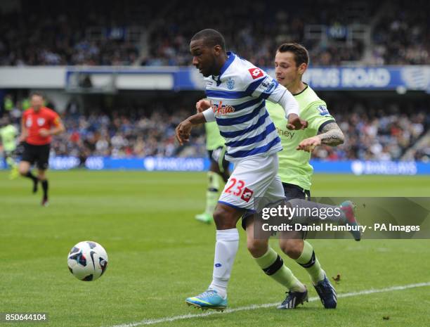 Queens Park Rangers' Junior Hoilett is fouled by Newcastle United's Mathieu Debuchy for a penalty during the Barclays Premier League match at Loftus...