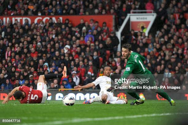 Manchester United goalkeeper David De Gea watches a shot from Swansea City's Wayne Routledge go just wide of the post