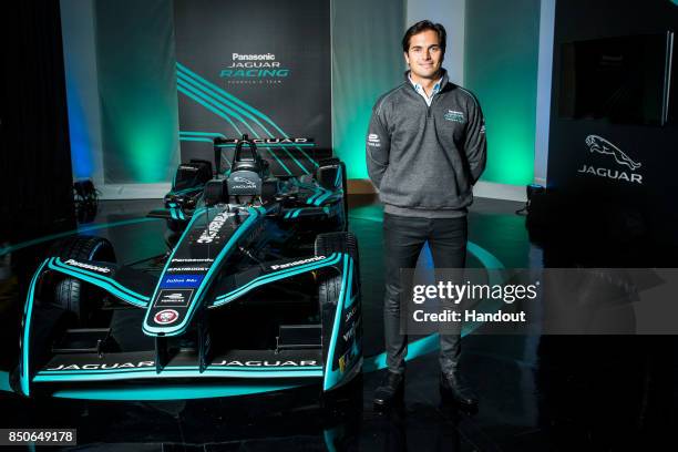 In this handout photo provided by Jaguar Racing, Driver Nelson Piquet Jr Poses with the new Jaguar Racing I-TYPE 2 Formula E car during the Panasonic...