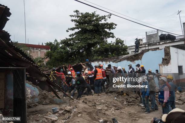 Rescue workers and volunteers remove debris from a building in the town of Jojutla de Juarez, Morelos State, Mexico, on Wednesday, Sept. 20, 2017. At...