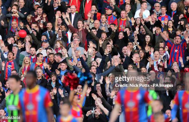 Crystal Palace fans applaud the players onto the pitch before the match