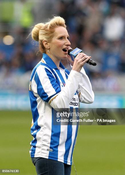 Opera singer Donna-Marie Hughes performs on the pitch before kick-off