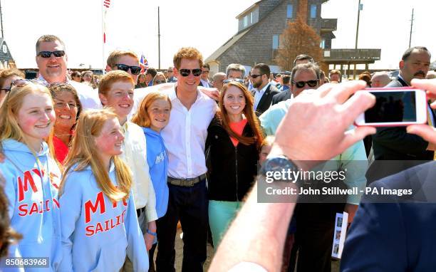 Prince Harry with Governor of New Jersey Chris Christie meets a family at Mantoloking, a borough of Ocean Heights, New Jersey as he visits one of the...