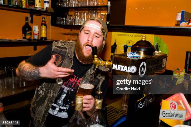 Photo of MUNICIPAL WASTE; Ryan Waste behind a bar pulling a pint