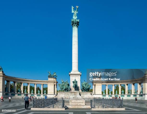 semi circular millennial monument and  bronze statue of archangel gabriel on the top of a column at hero's square, budapest hungary - archangel stock pictures, royalty-free photos & images