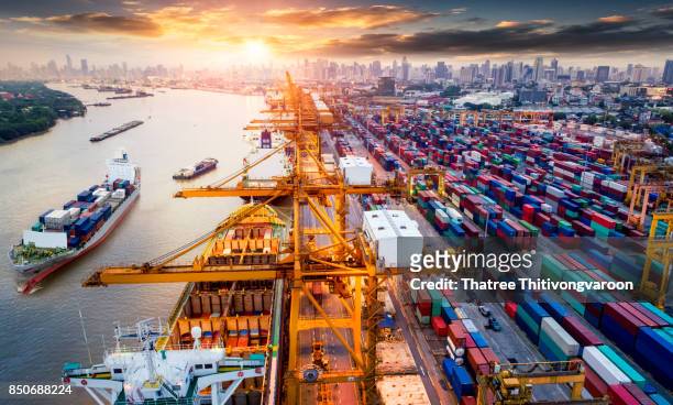 logistics and transportation of container cargo ship and cargo plane with working crane bridge in shipyard - dársena fotografías e imágenes de stock