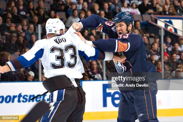 Steve MacIntyre of the Edmonton Oilers trades punches with David Koci of the Tampa Bay Lightning during a fight at Rexall Place on February 24, 2009...