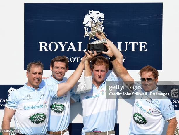 Michael Carrazza, Malcolm Borwick, Prince Harry and Marc Ganzi, lift the winners trophy following the Sentebale Royal Salute Polo Cup, at the...